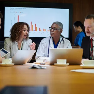 Image of medical staff sitting around a conference table.