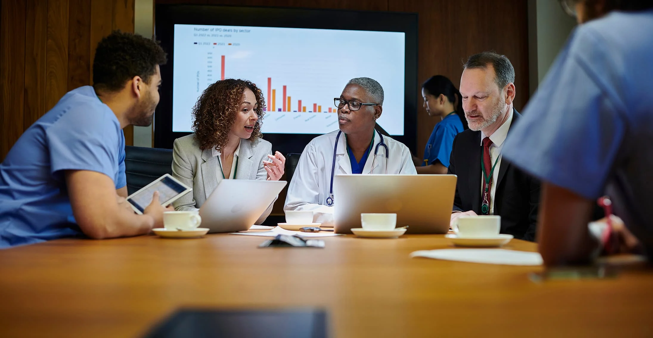 Image of medical staff sitting around a conference table.