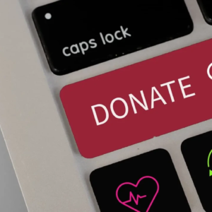 A laptop keyboard with a red "Donate" button