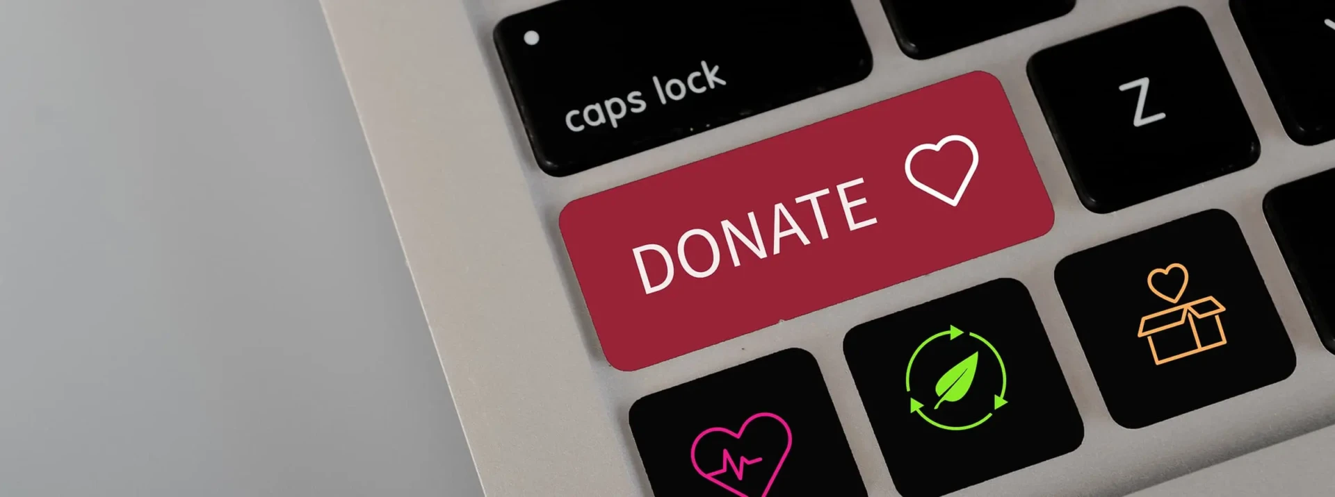 A laptop keyboard with a red "Donate" button